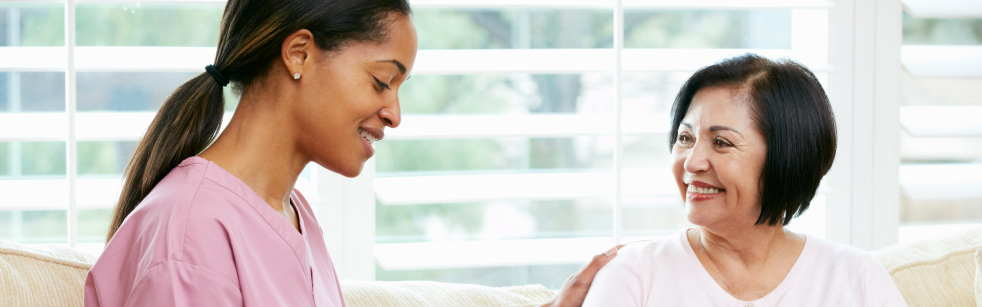 aide and elderly woman smiling